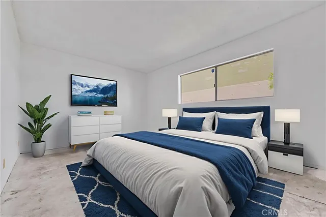 a bedroom with a large bed and a couch