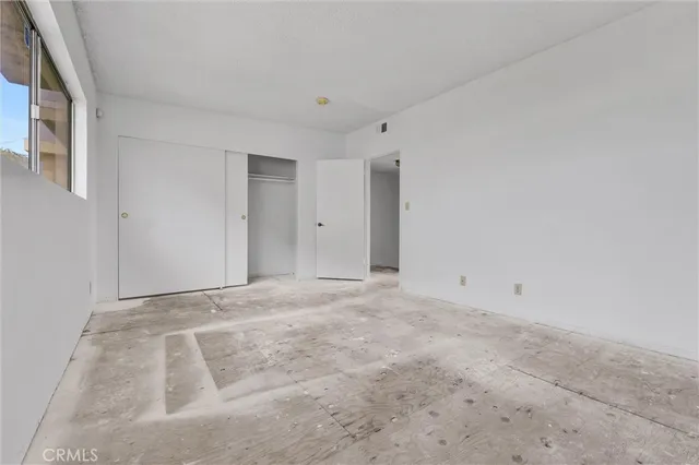 a view of a hallway with wooden shelves