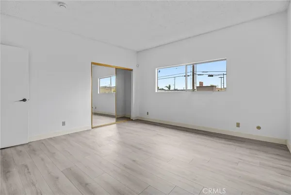 a bedroom with a bed and a potted plant