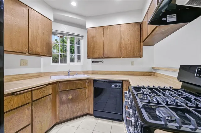 a kitchen with a sink a stove and cabinets