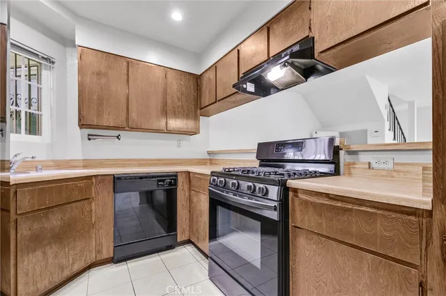 a kitchen with stainless steel appliances granite countertop a stove and a refrigerator