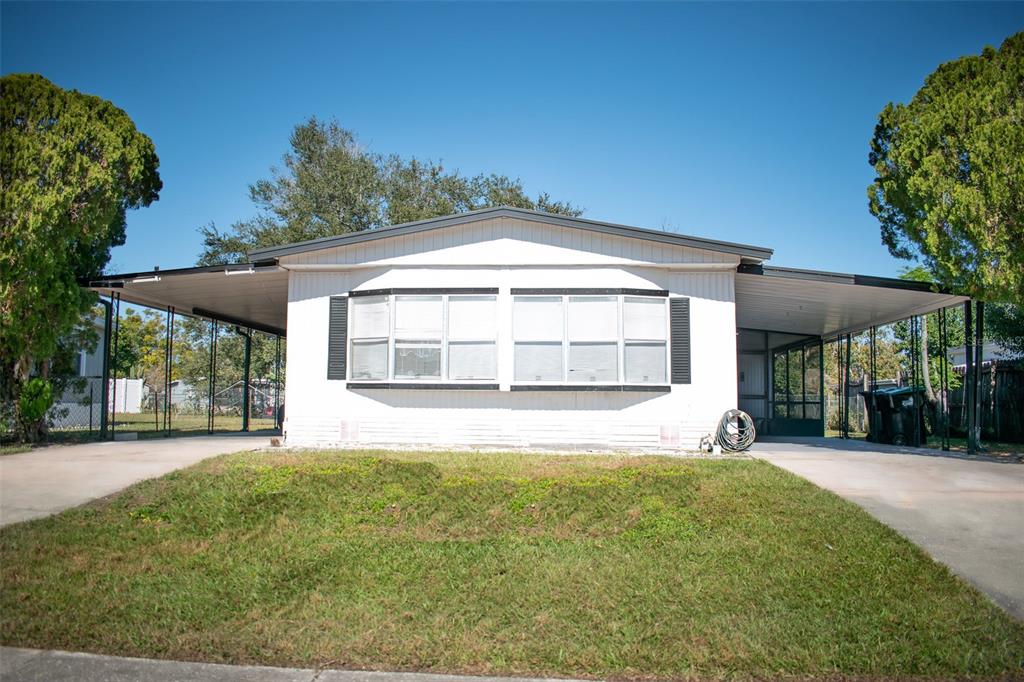 6719 Pompeii Road Orlando, FL 32822 - Photo 1 of 1 front view of a house with a yard
