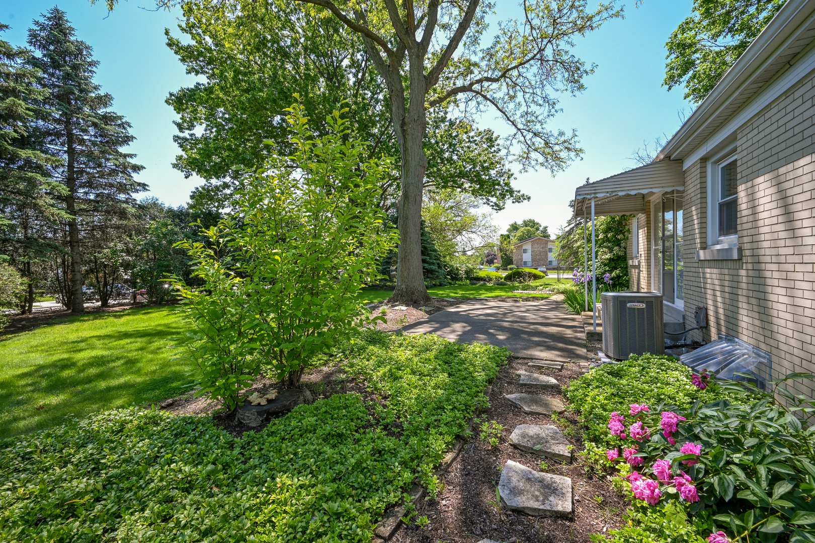 325 South Lambert Road Glen Ellyn, IL 60137 - Photo 26 of 32 a view of a garden with plants and large trees