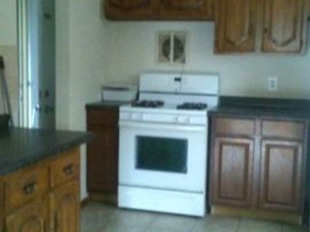 9029 Sproat Avenue Oak Lawn, IL 60453 - Photo 5 of 8 a kitchen with a stove and cabinets