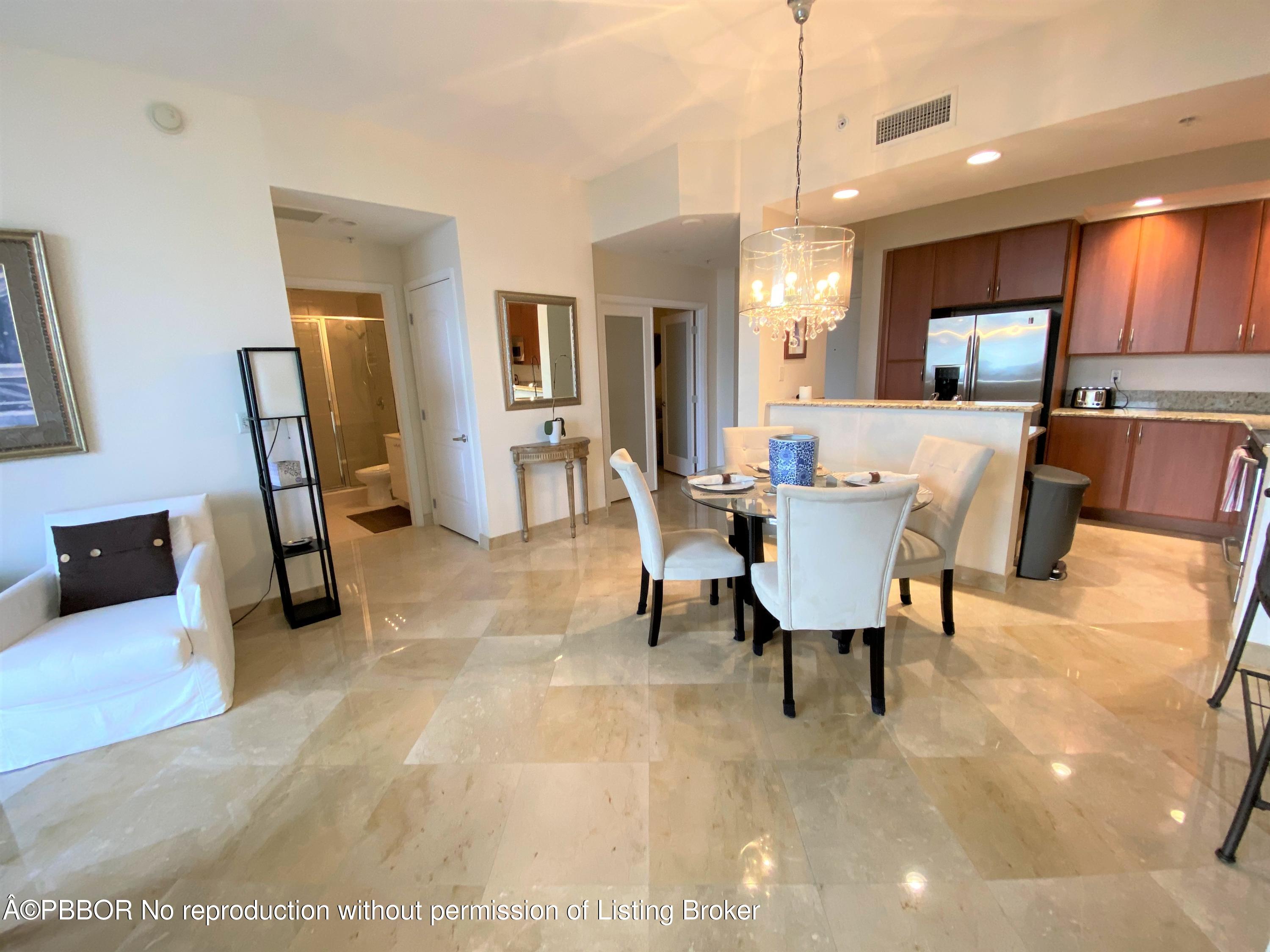 801 South Olive Avenue, Unit 903 West Palm Beach, FL 33401 - Photo 13 of 55 a view of a livingroom with furniture and a flat screen tv