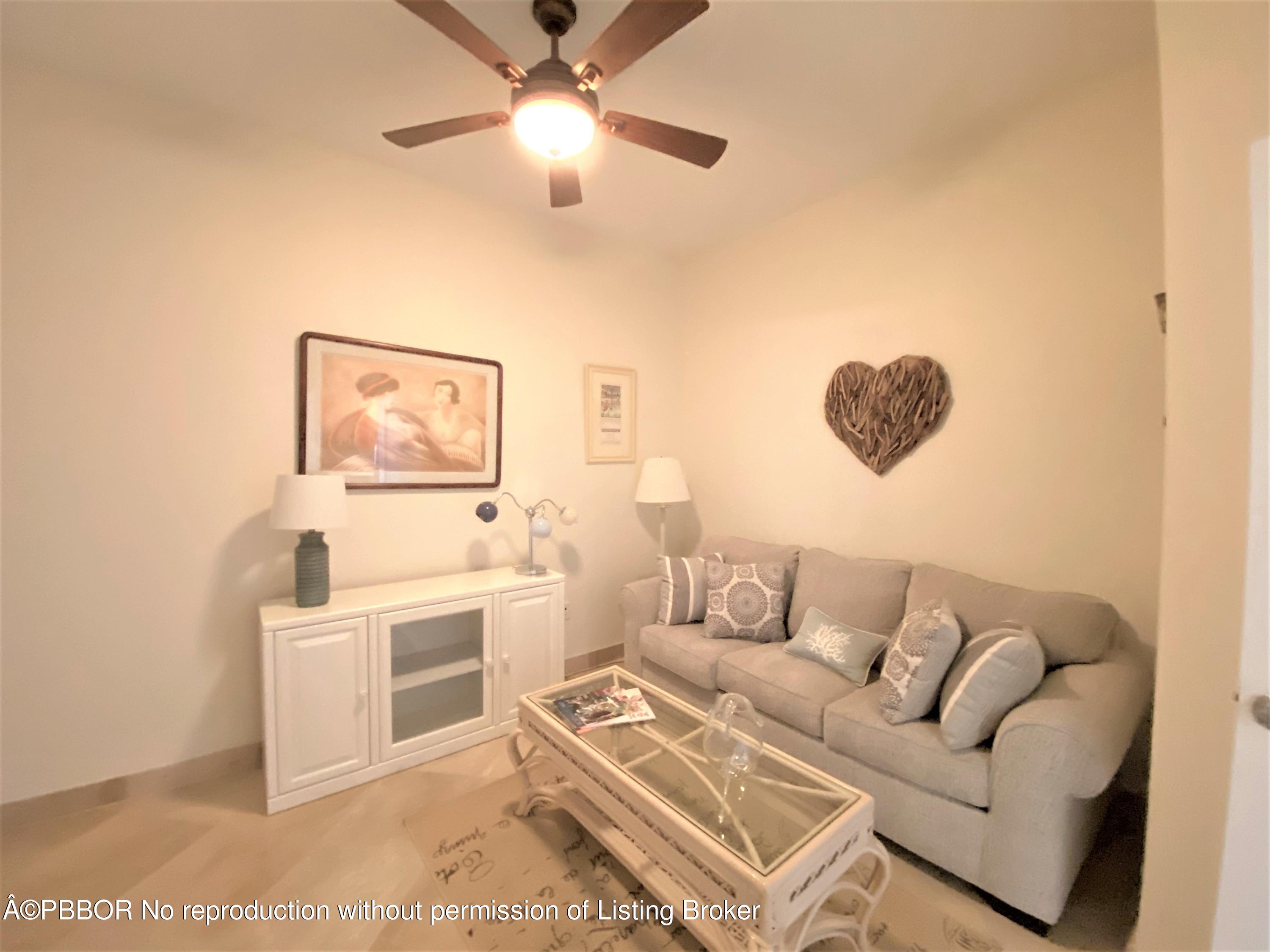 801 South Olive Avenue, Unit 903 West Palm Beach, FL 33401 - Photo 25 of 55 a living room with furniture and a chandelier