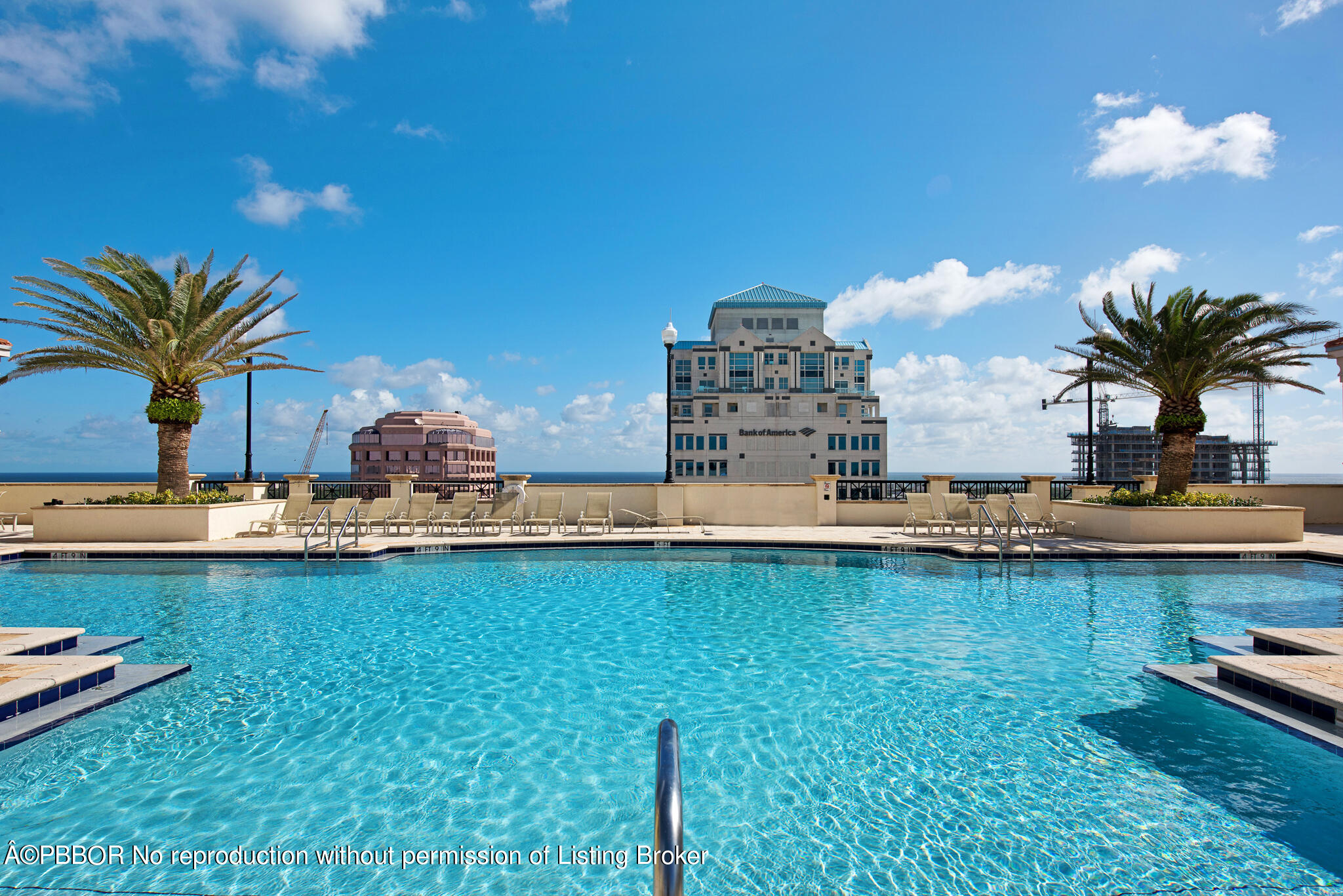 801 South Olive Avenue, Unit 903 West Palm Beach, FL 33401 - Photo 40 of 55 a view of a swimming pool with a table and chairs