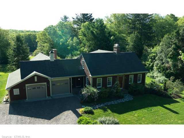 144 Cove Road Stonington, CT 06378 - Photo 1 of 1 a front view of a house with a yard