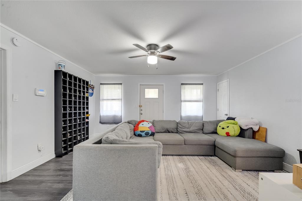 1226 Pine Street Orlando, FL 32824 - Photo 11 of 46 a living room with furniture stairs and a window