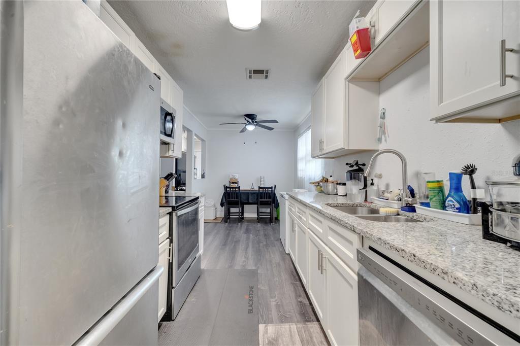 1226 Pine Street Orlando, FL 32824 - Photo 17 of 46 a kitchen with sink cabinets and window