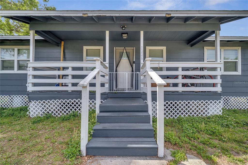 1226 Pine Street Orlando, FL 32824 - Photo 2 of 46 a view of a house with a large window stairs and a yard