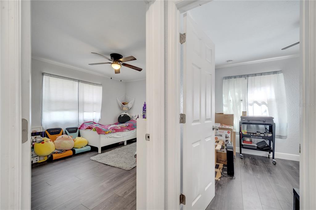 1226 Pine Street Orlando, FL 32824 - Photo 26 of 46 a bedroom with furniture and a chandelier