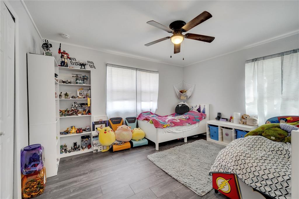 1226 Pine Street Orlando, FL 32824 - Photo 27 of 46 a bedroom with bed and a chandelier