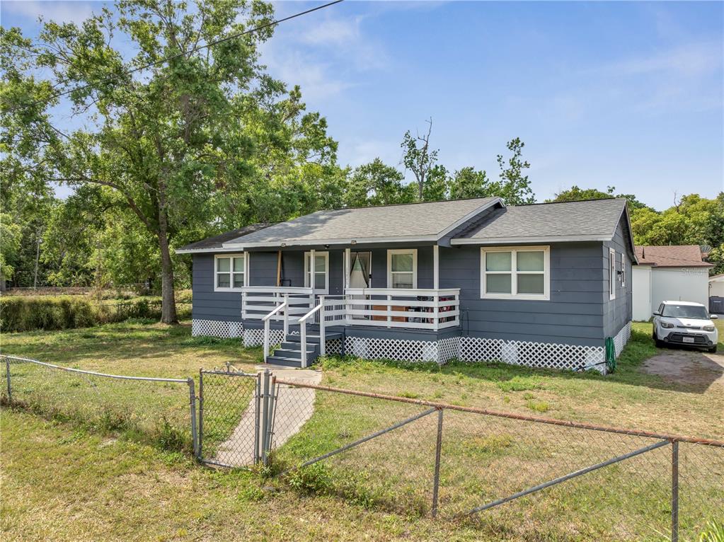 1226 Pine Street Orlando, FL 32824 - Photo 35 of 46 a view of a house with swimming pool and a yard