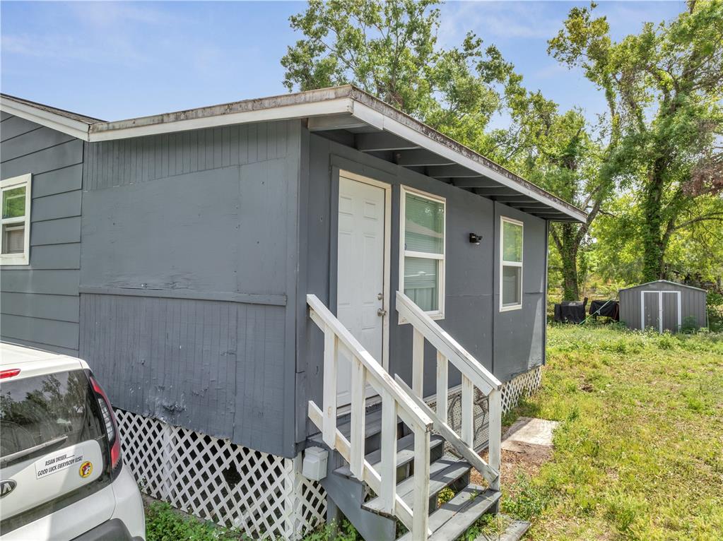 1226 Pine Street Orlando, FL 32824 - Photo 36 of 46 a view of house with wooden deck and furniture