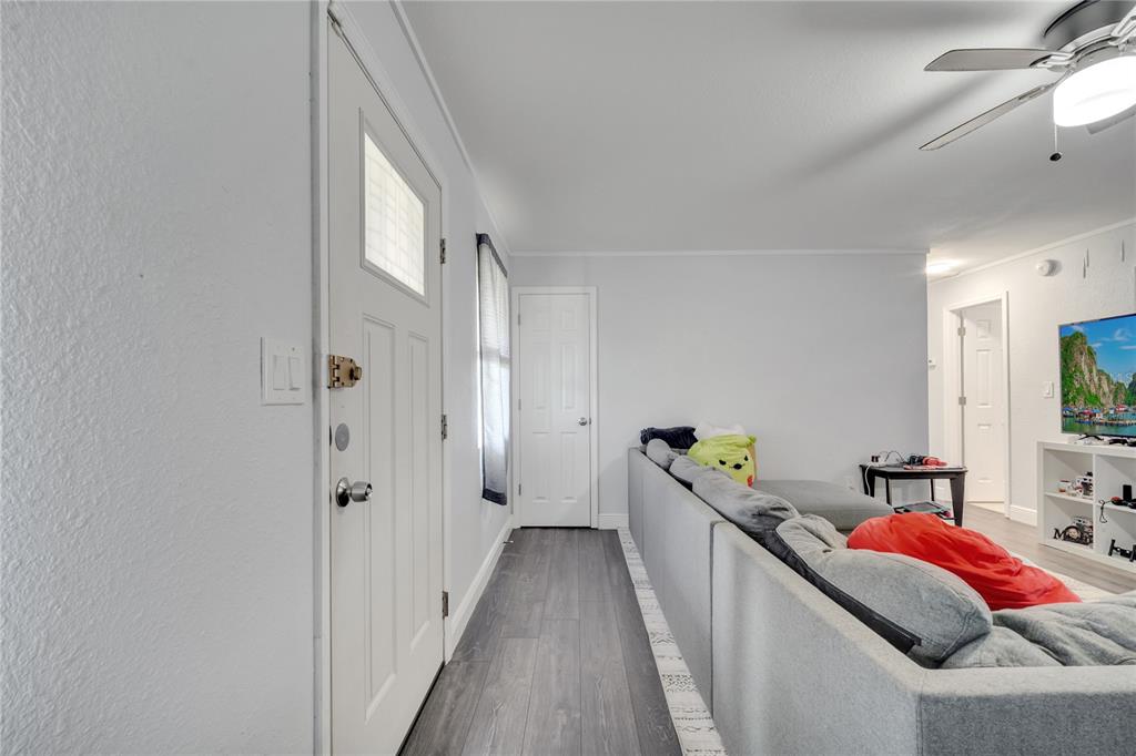 1226 Pine Street Orlando, FL 32824 - Photo 7 of 46 a hallway with a bed and a chandelier