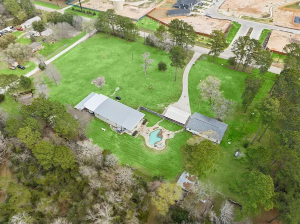 an aerial view of a house with a yard