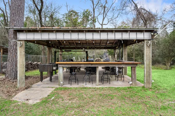 a view of a chair and table in backyard of the house