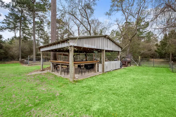 a view of a house with backyard porch and sitting area