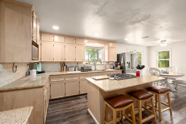 a kitchen with a sink stove and cabinets