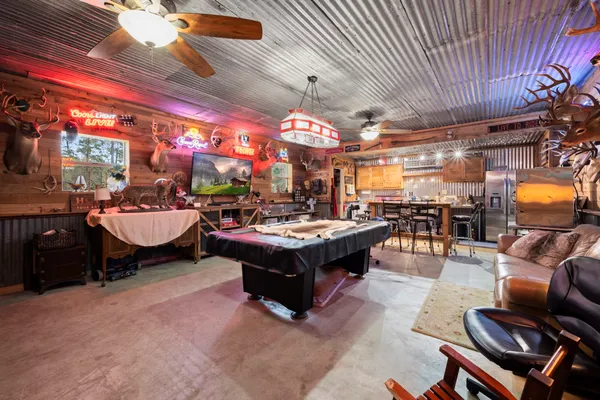 a living room with furniture a rug and a chandelier