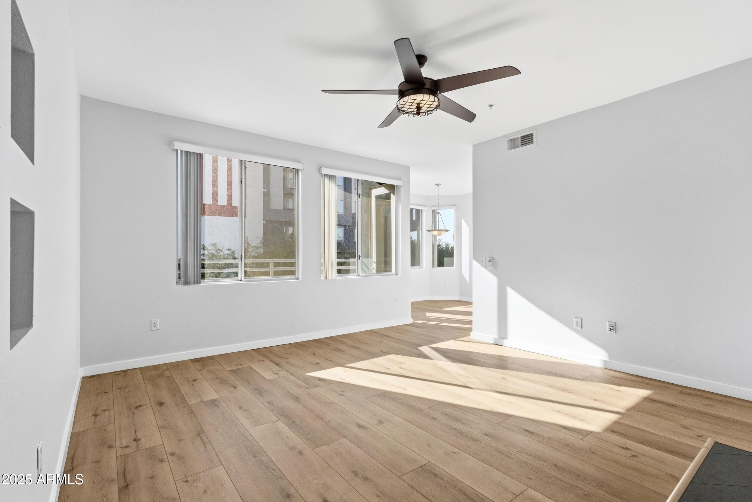 3633 North 3rd Avenue, Unit 2009 Phoenix, AZ 85013 - Photo 10 of 36 a view of empty room with wooden floor and fan