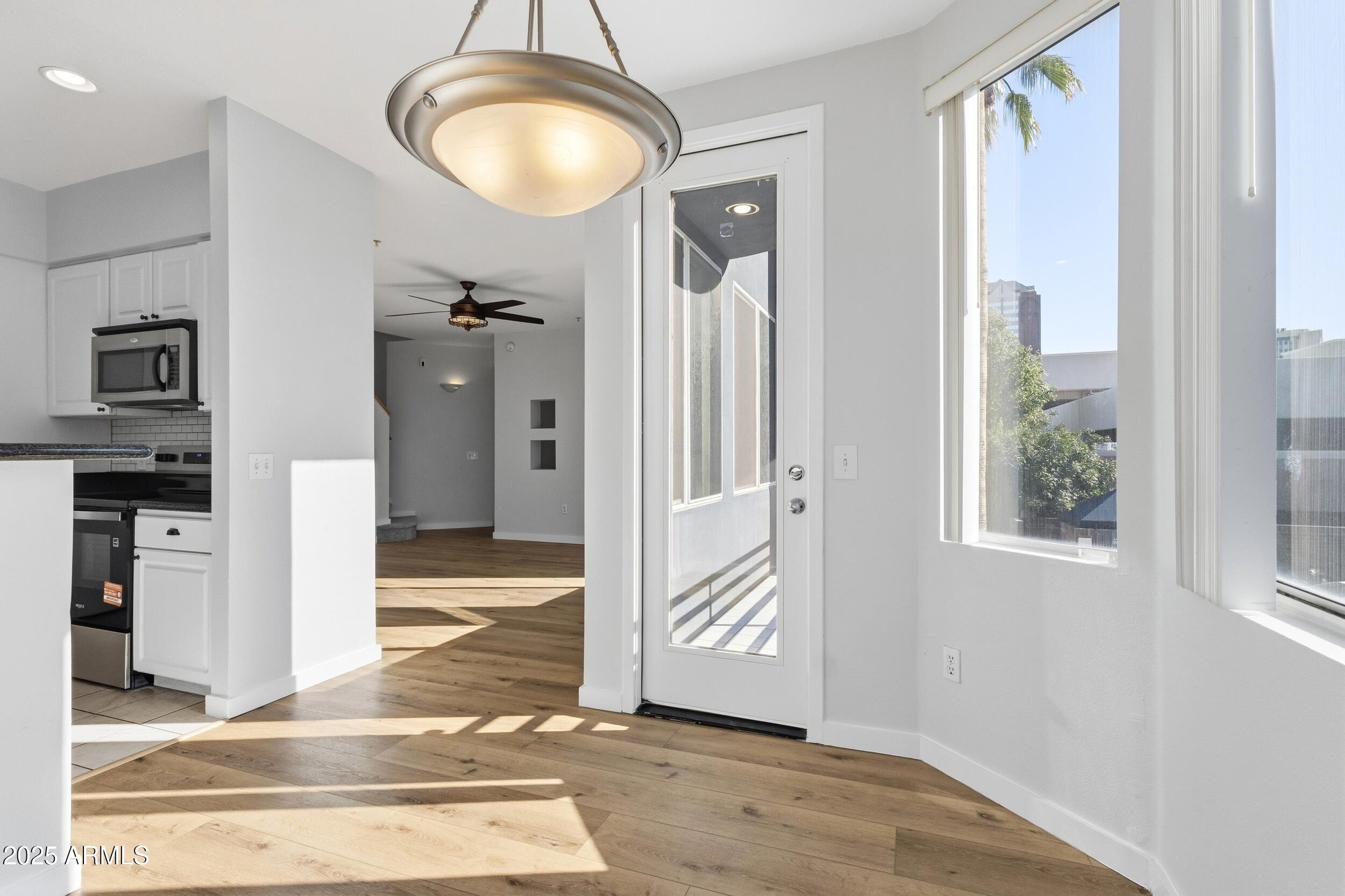 3633 North 3rd Avenue, Unit 2009 Phoenix, AZ 85013 - Photo 12 of 36 a view of a livingroom with a dinning area wooden floor and a kitchen