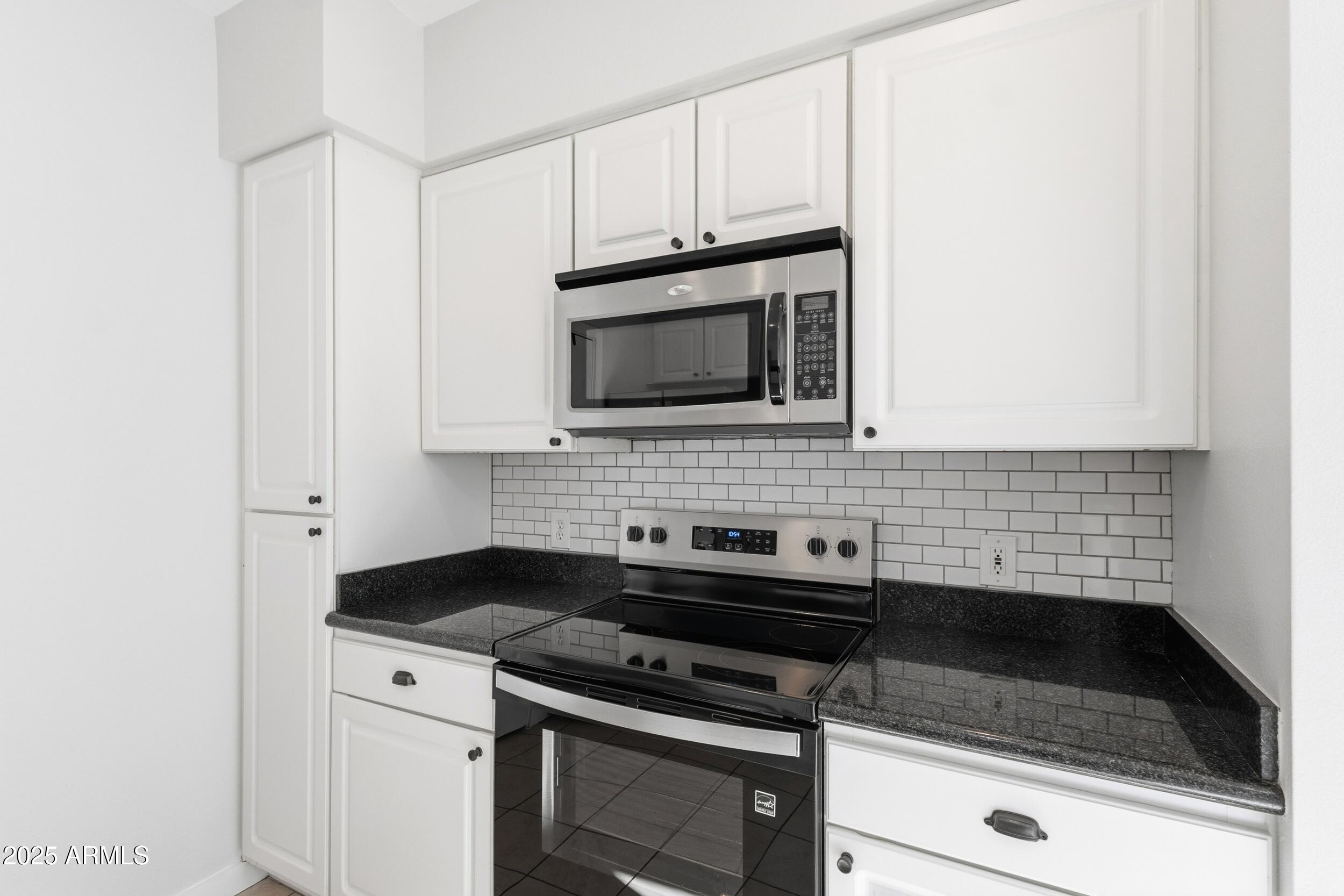 3633 North 3rd Avenue, Unit 2009 Phoenix, AZ 85013 - Photo 15 of 36 a kitchen with granite countertop white cabinets and stainless steel appliances