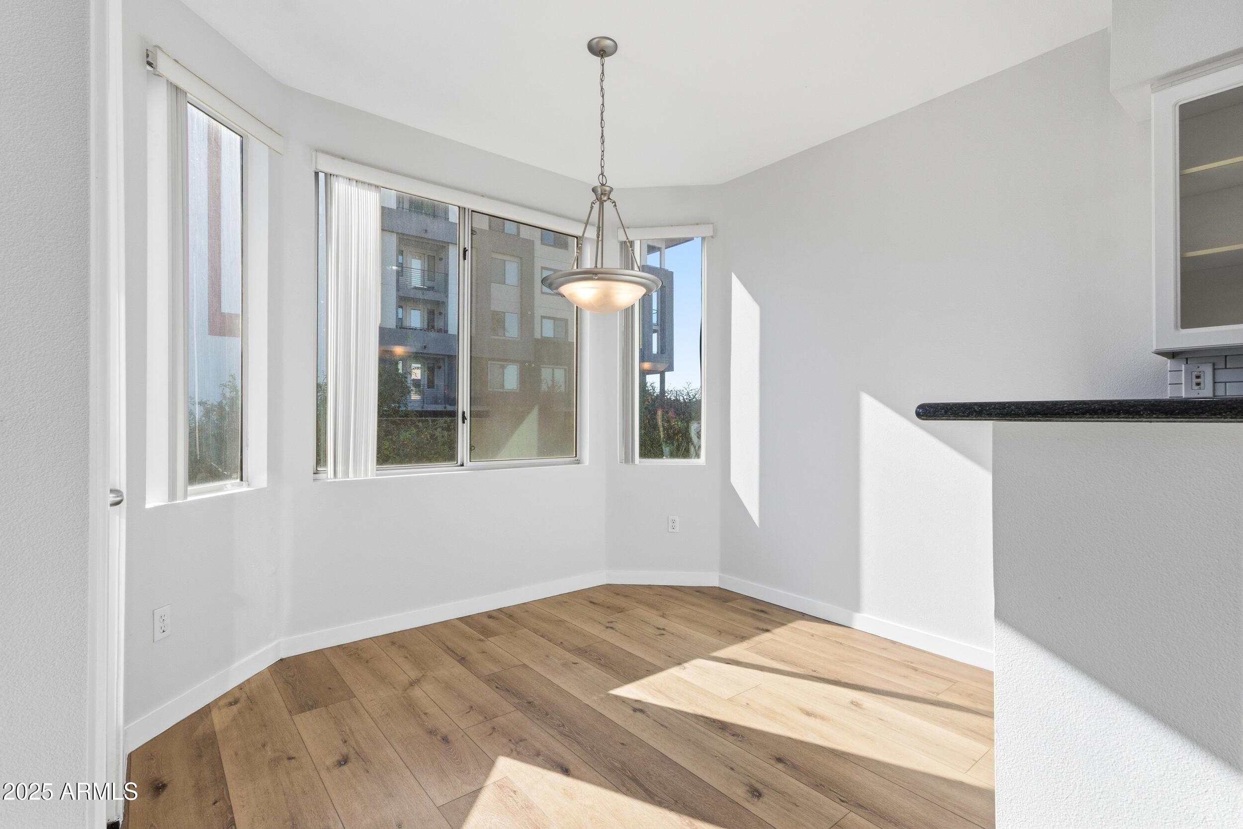 3633 North 3rd Avenue, Unit 2009 Phoenix, AZ 85013 - Photo 2 of 36 a view of empty room with wooden floor and fan
