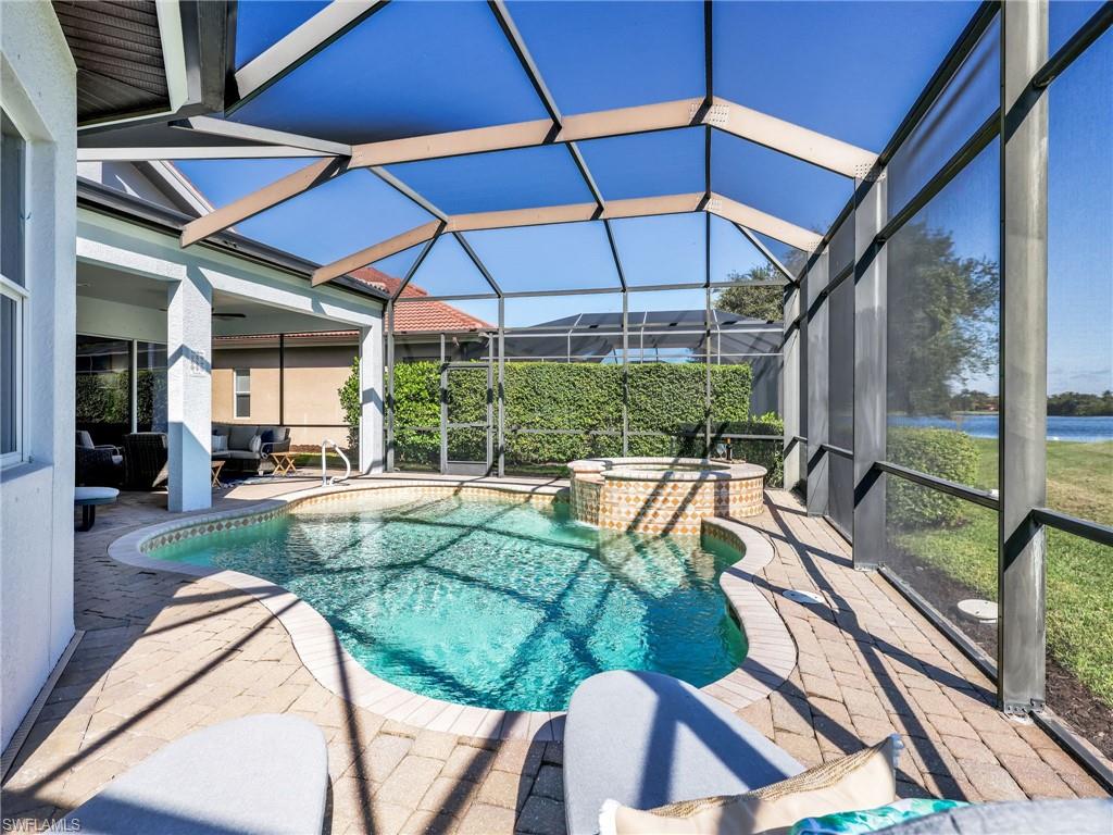 6096 Dogleg Drive Naples, FL 34113 - Photo 19 of 49 a view of a backyard with a swimming pool