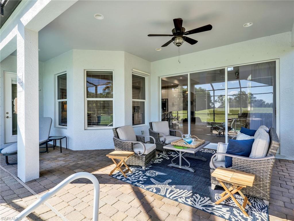 6096 Dogleg Drive Naples, FL 34113 - Photo 20 of 49 a living room with furniture or window and a table