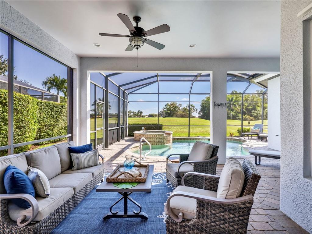 6096 Dogleg Drive Naples, FL 34113 - Photo 21 of 49 a living room with furniture and a large window