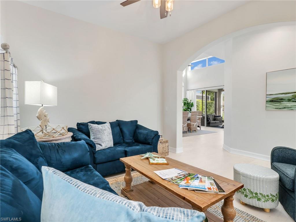 6096 Dogleg Drive Naples, FL 34113 - Photo 24 of 49 a living room with furniture and a table