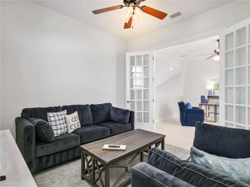 6096 Dogleg Drive Naples, FL 34113 - Photo 25 of 49 a living room with furniture and a window