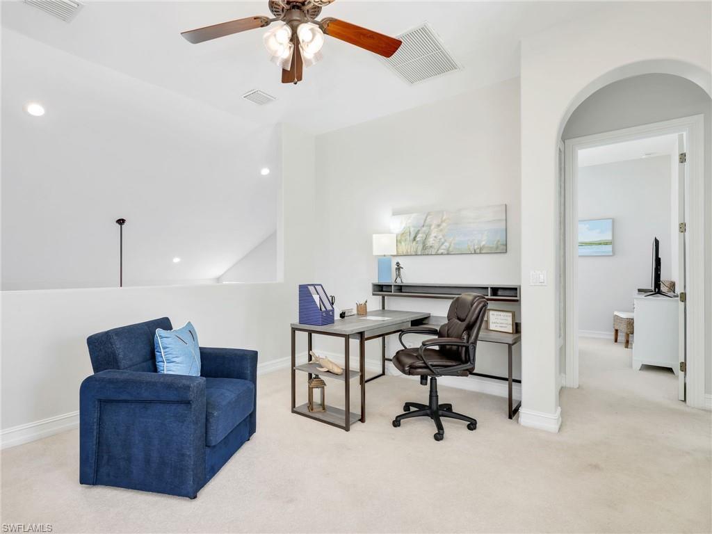 6096 Dogleg Drive Naples, FL 34113 - Photo 27 of 49 a living room with furniture and a ceiling fan