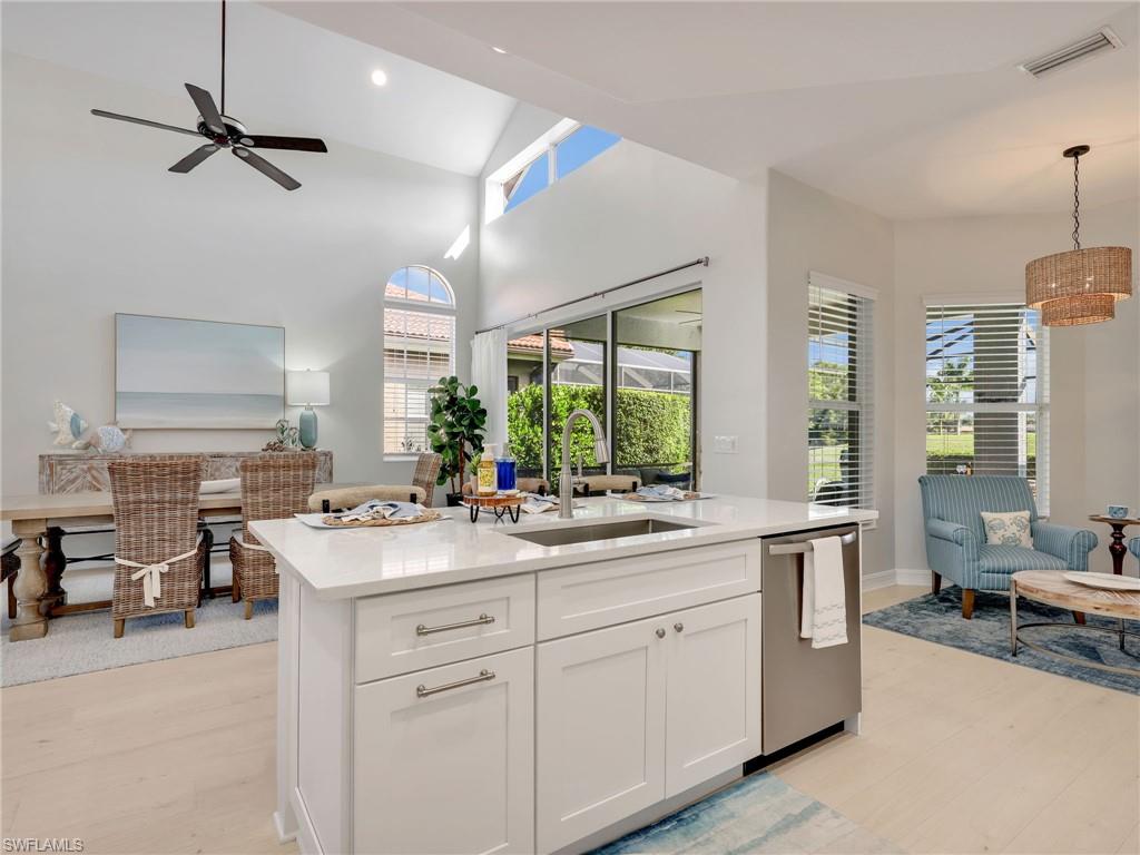 6096 Dogleg Drive Naples, FL 34113 - Photo 3 of 49 a kitchen with a sink stove and cabinets