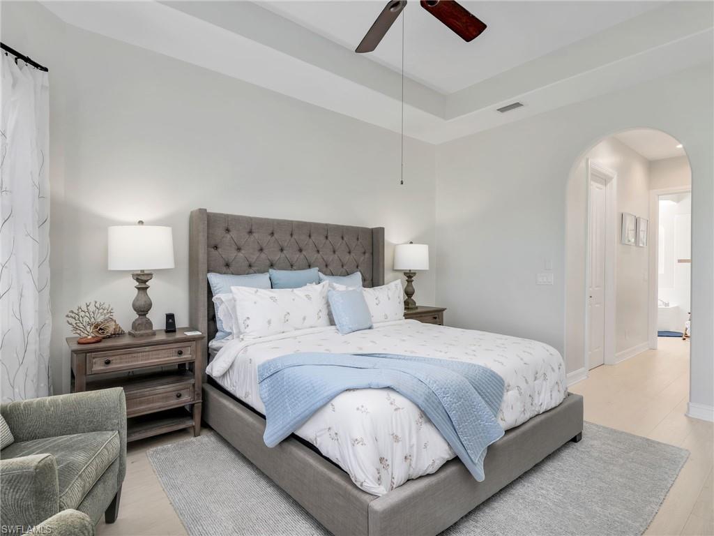 6096 Dogleg Drive Naples, FL 34113 - Photo 31 of 49 a bedroom with a bed and ceiling fan