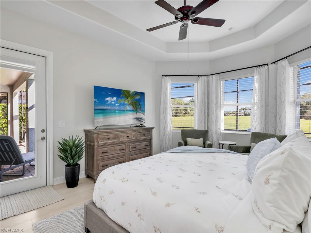 6096 Dogleg Drive Naples, FL 34113 - Photo 33 of 49 a bedroom with a bed and a large mirror