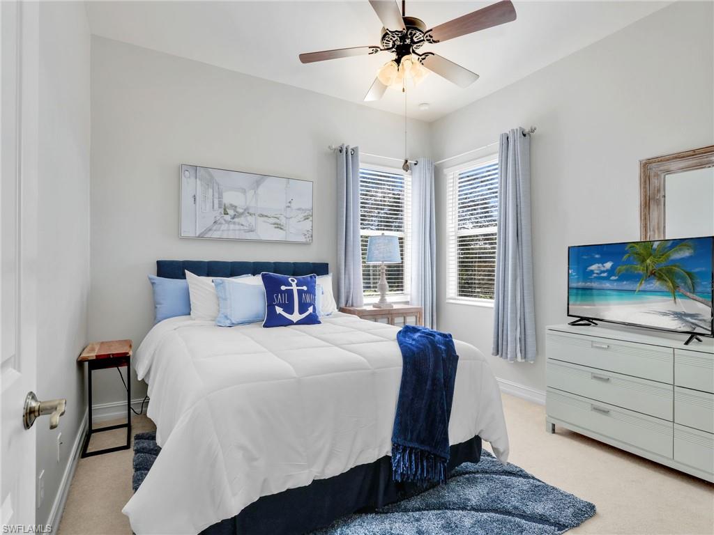 6096 Dogleg Drive Naples, FL 34113 - Photo 38 of 49 a bedroom with a large bed and a window