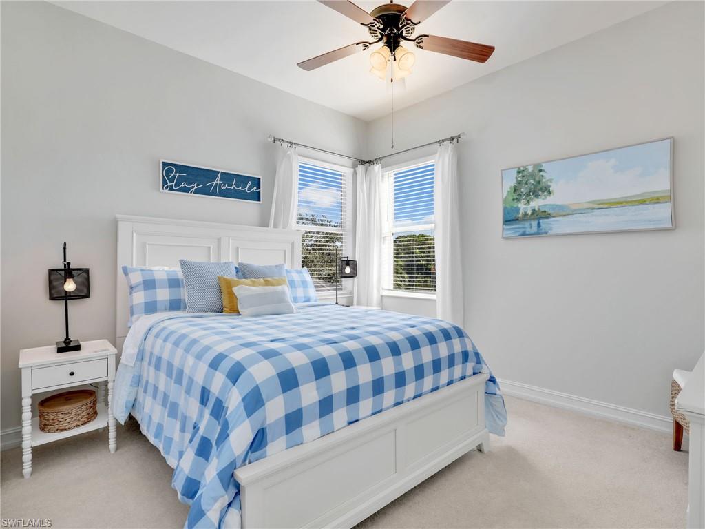 6096 Dogleg Drive Naples, FL 34113 - Photo 40 of 49 a bedroom with a bed and a chandelier