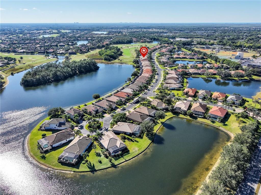 6096 Dogleg Drive Naples, FL 34113 - Photo 45 of 49 an aerial view of a house with a lake view