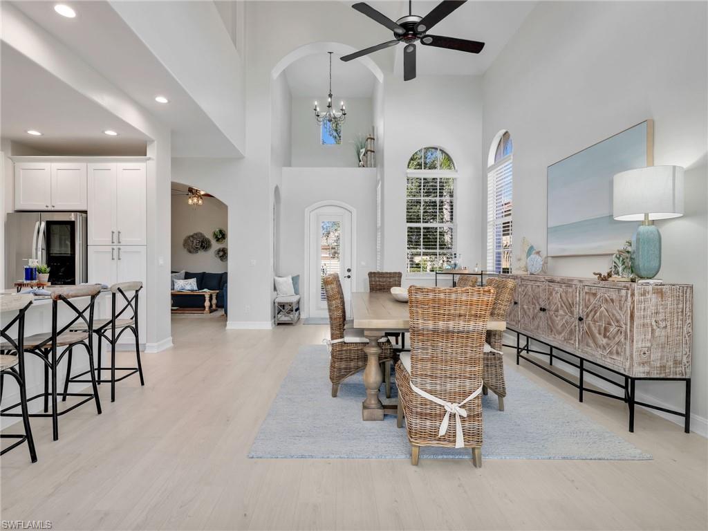 6096 Dogleg Drive Naples, FL 34113 - Photo 9 of 49 a living room with furniture and a large window