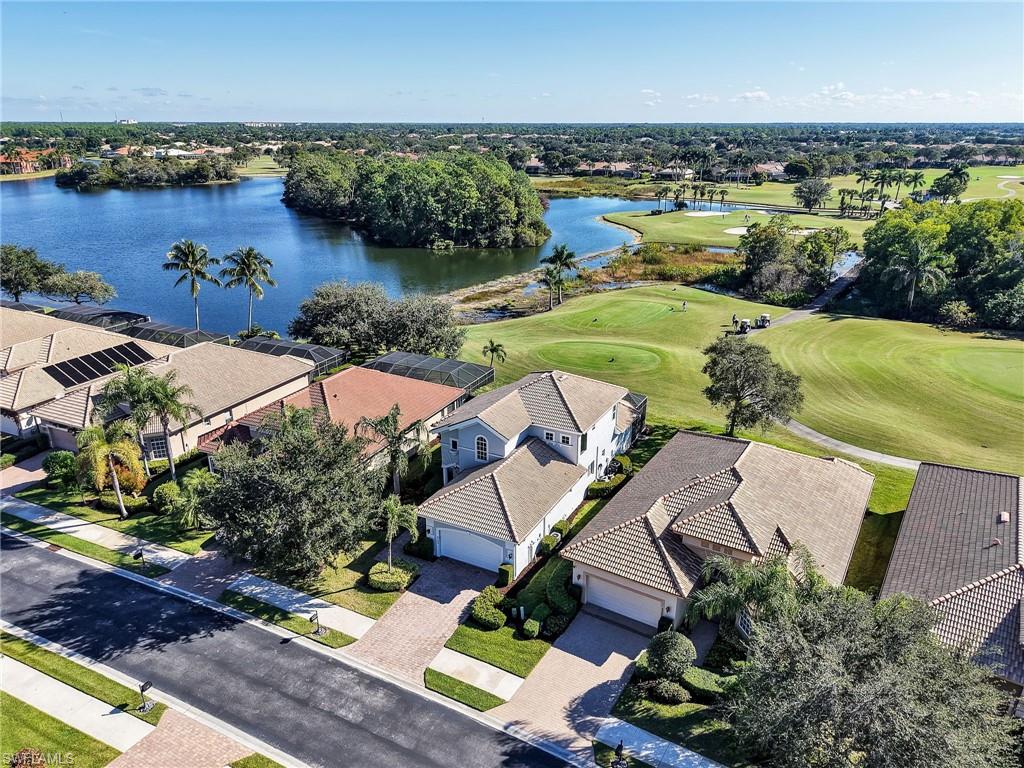 6096 Dogleg Drive Naples, FL 34113 - Photo 10 of 49 an aerial view of a house with garden space and lake view