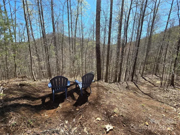a view of a backyard with chairs