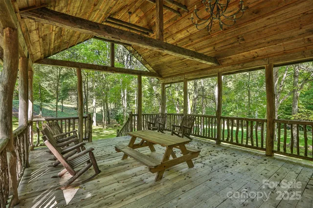a living room with furniture a fireplace and a large window