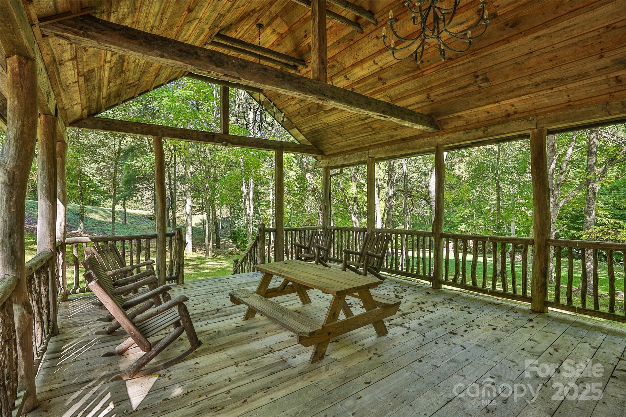 Lot 39 Sweet Spring Trail, Unit 39 Glenville, NC 28736 - Photo 26 of 27 a balcony with wooden floor outdoor seating and yard in the back
