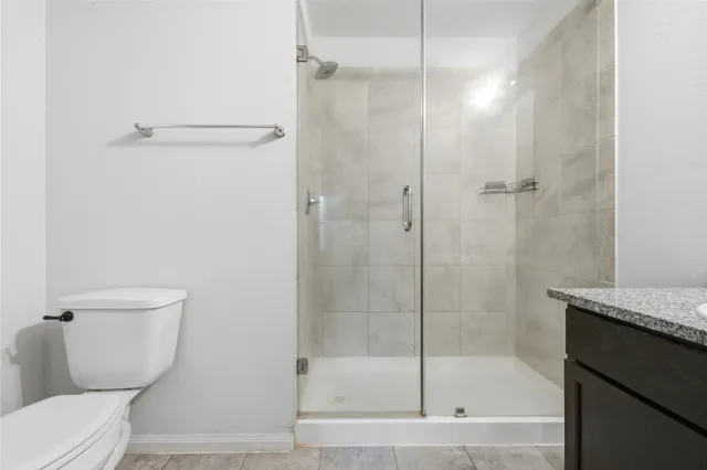 a bathroom with a shower and a toilet
