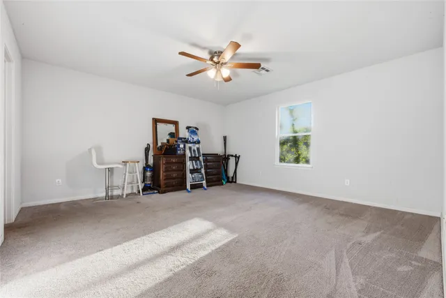 a view of a livingroom with a ceiling fan and a window