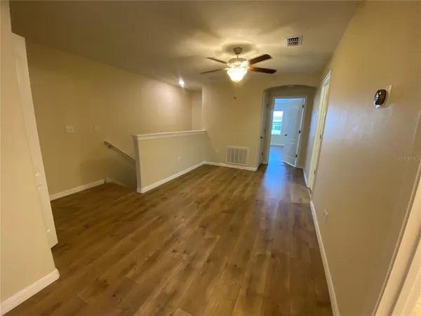 wooden floor in an empty room with a mirror