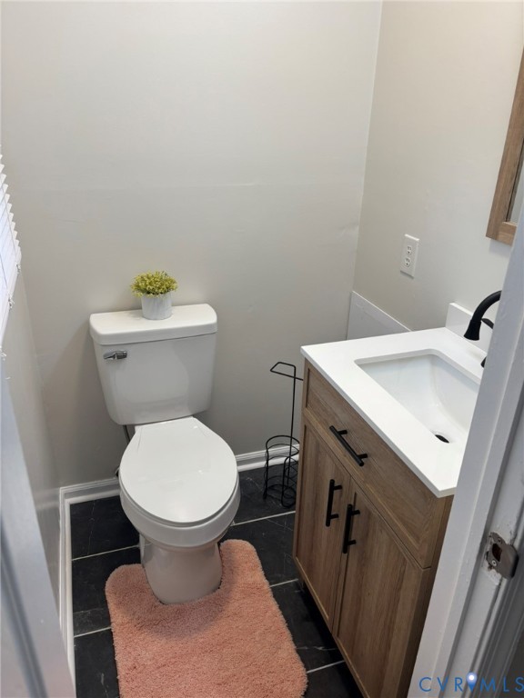 1185 Erica Road Montross, VA 22520 - Photo 24 of 32 Half bathroom with vanity and dark tile patterned